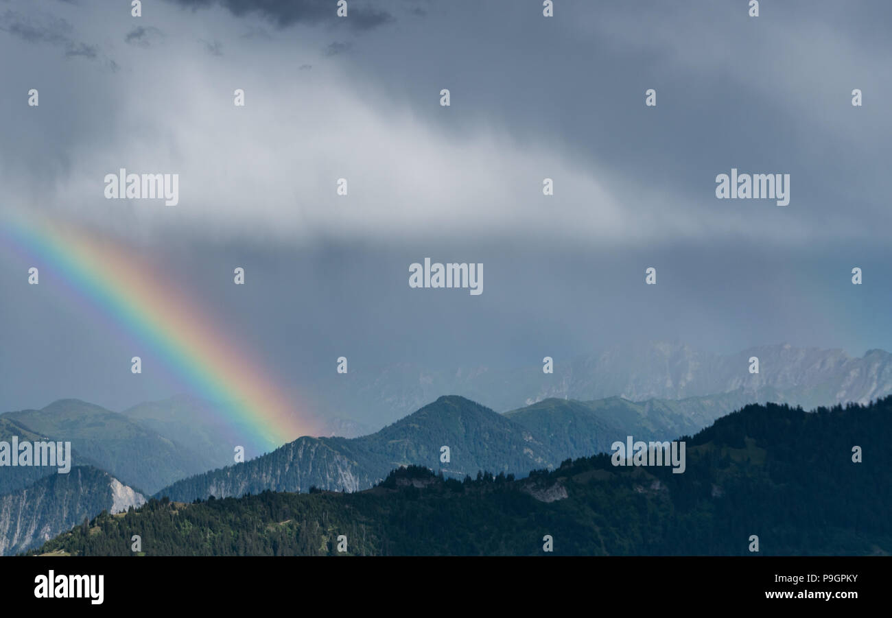 mountain landscape after a summer thunderstorm with a rainbow Stock Photo