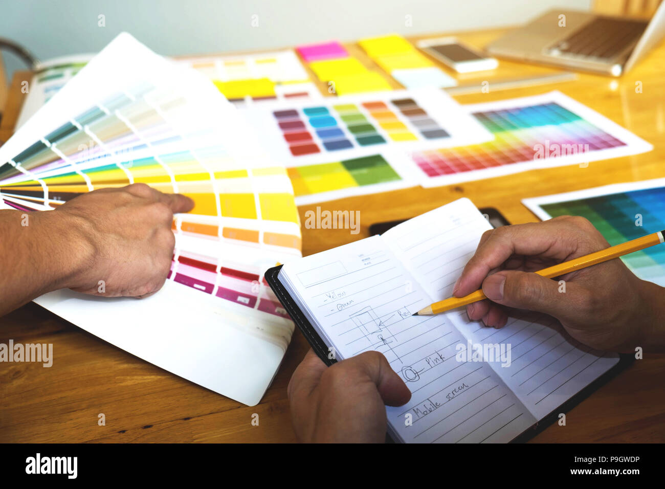 Graphic designers choose colors from the color bands samples for design .Designer graphic creativity work concept . Stock Photo