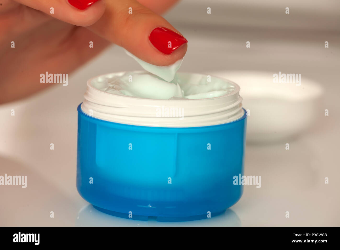 taking the cream from the jar with the finger Stock Photo Alamy