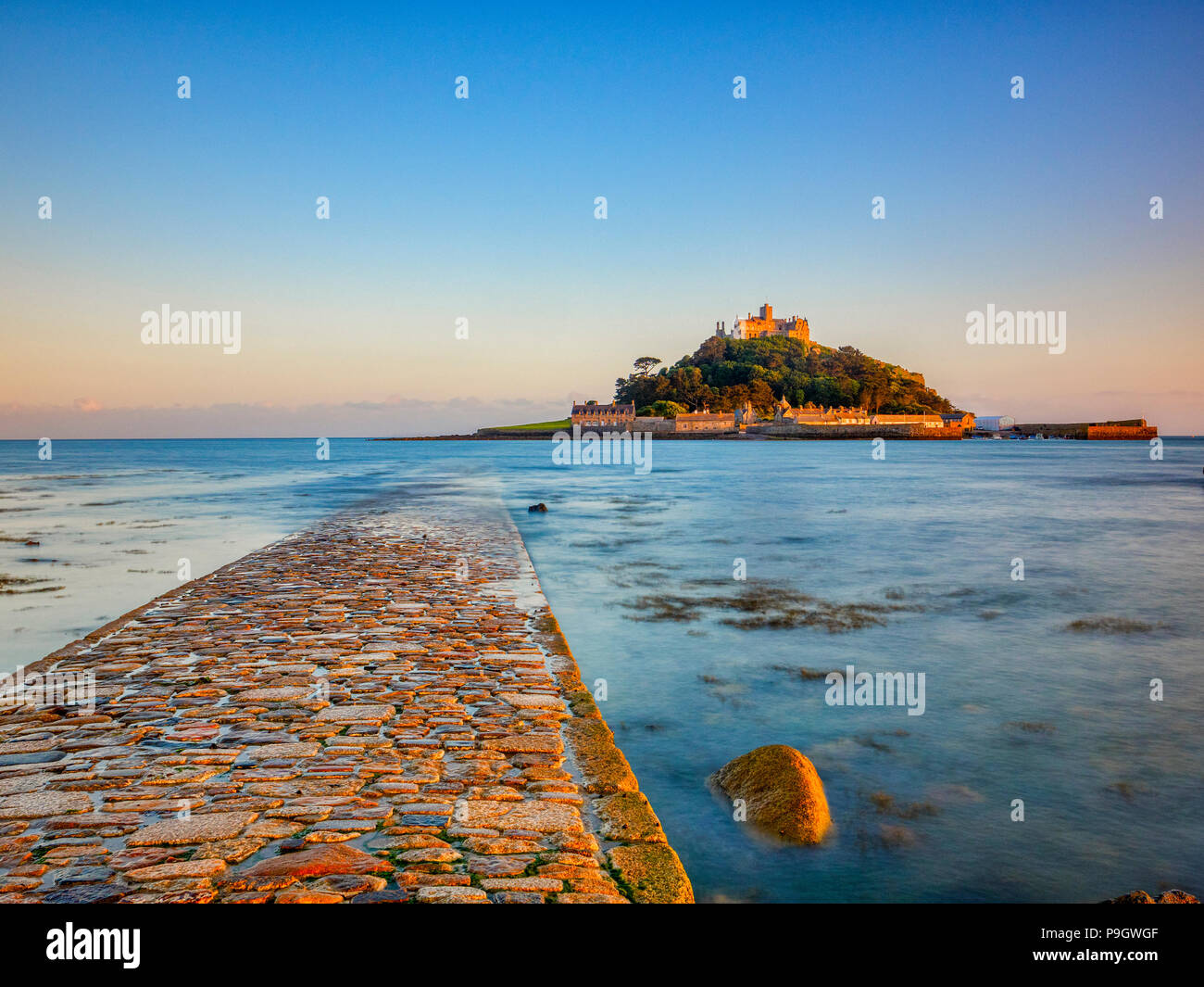 St Michael's Mount at Marazion, Cornwall, UK at evening, with part of the causeway linking it to the mainland. Stock Photo