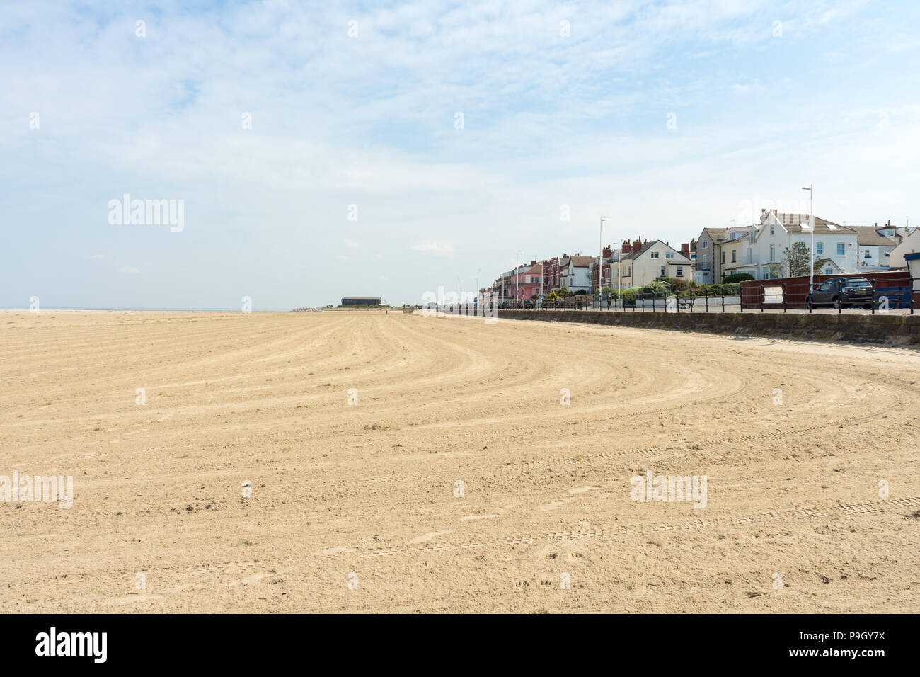 View of Hoylake, Wirral, UK from the beach with tyre tracks in the sand Stock Photo