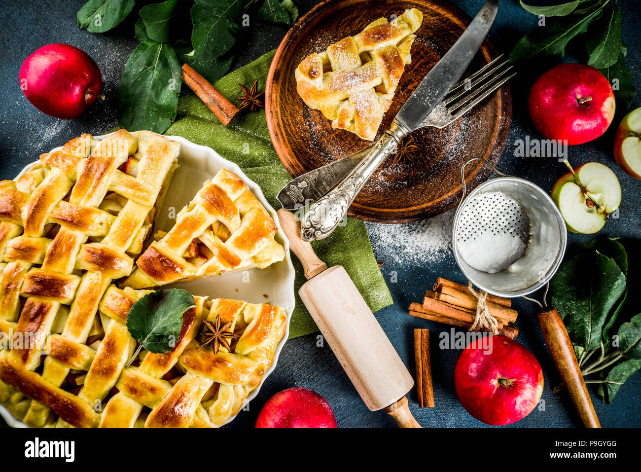 Traditional autumn baking, homemade apple pie with cinnamon, dark blue
