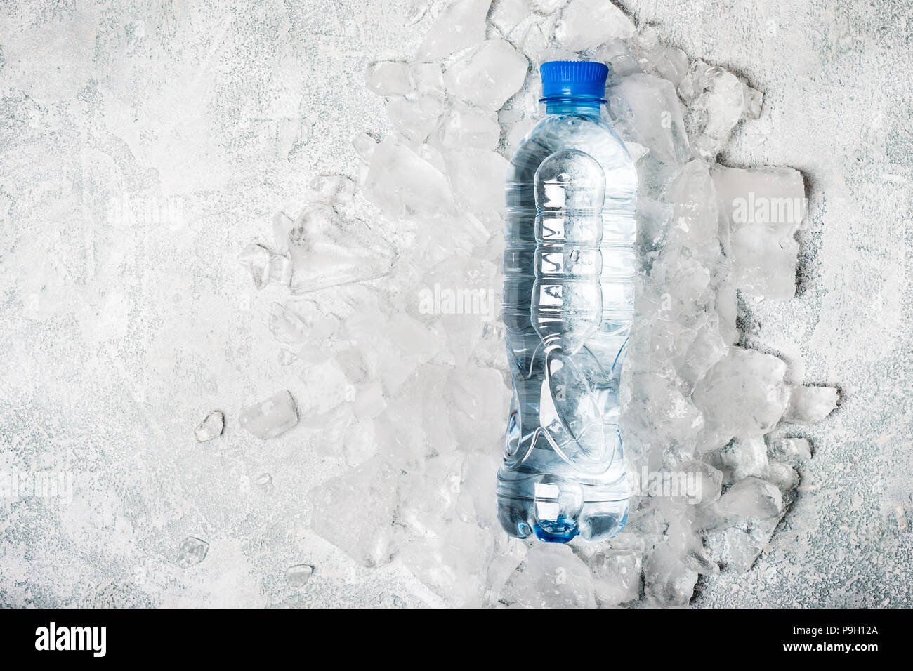 water in a bottle on a background of ice. Health detox concept Stock