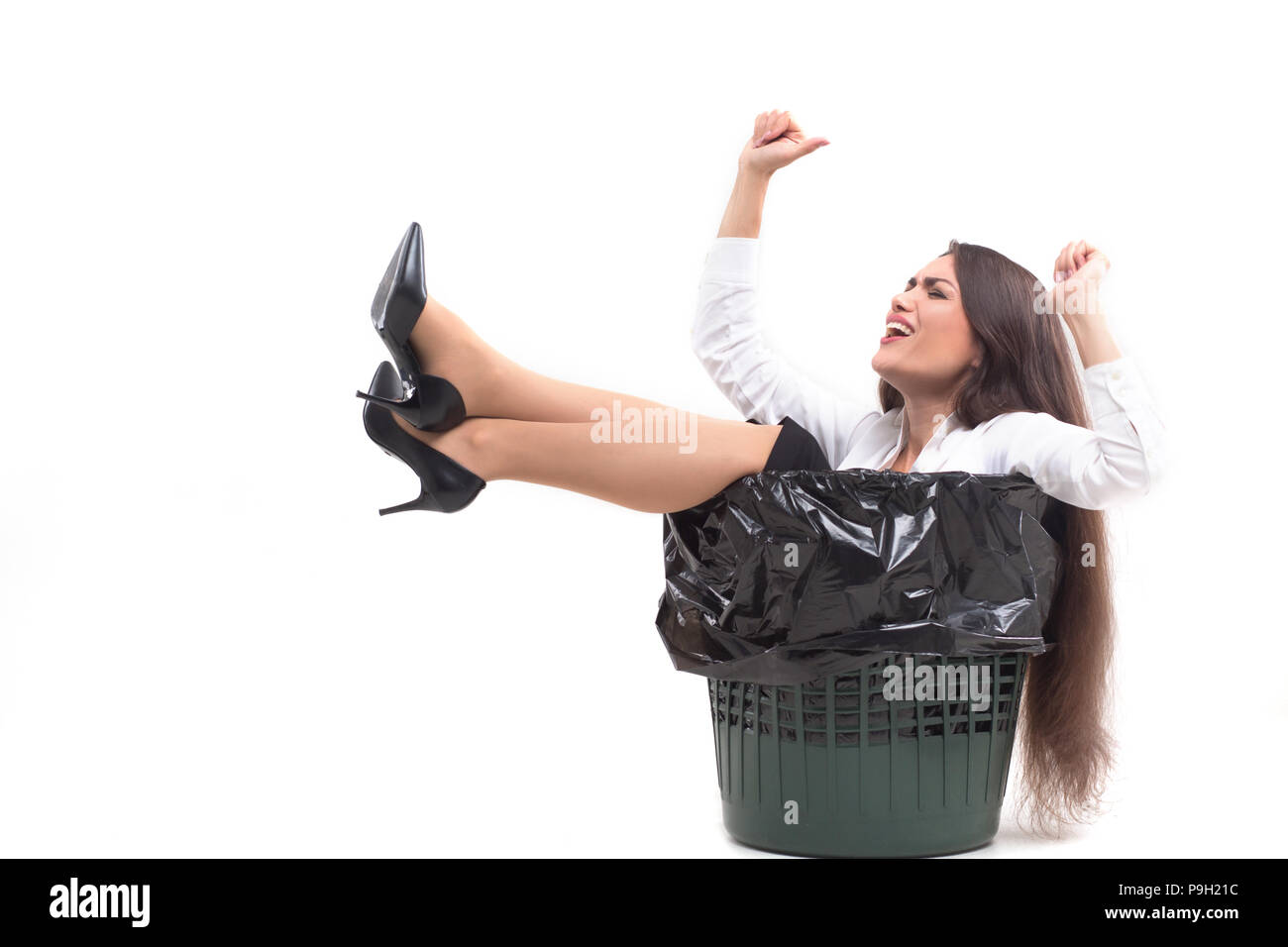 Crazy woman sitting in trash can. Stock Photo