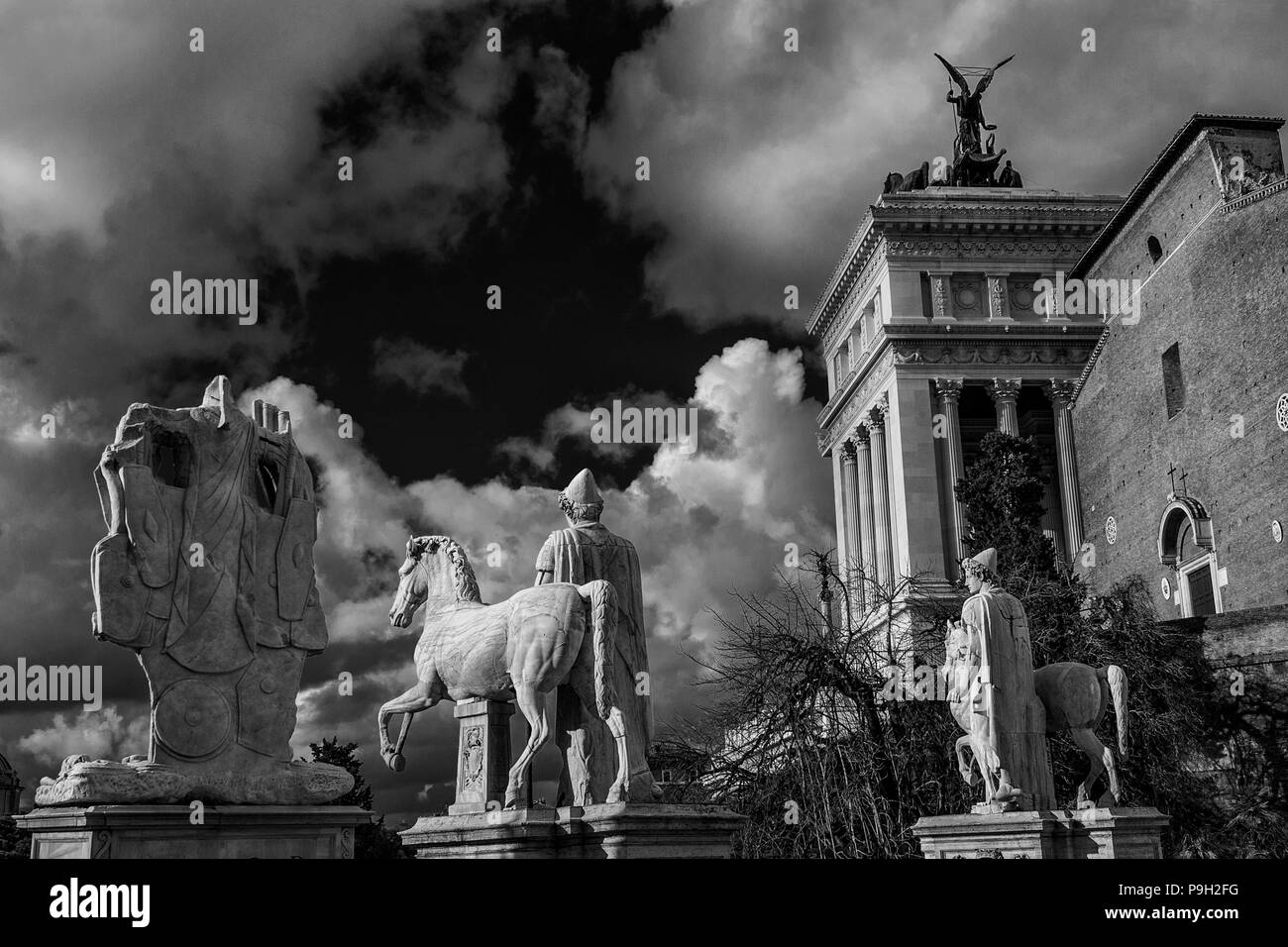 Capitoline Hill monumental balustrade with ancient roman statues and clouds in the historic center of Rome (Black and White) Stock Photo