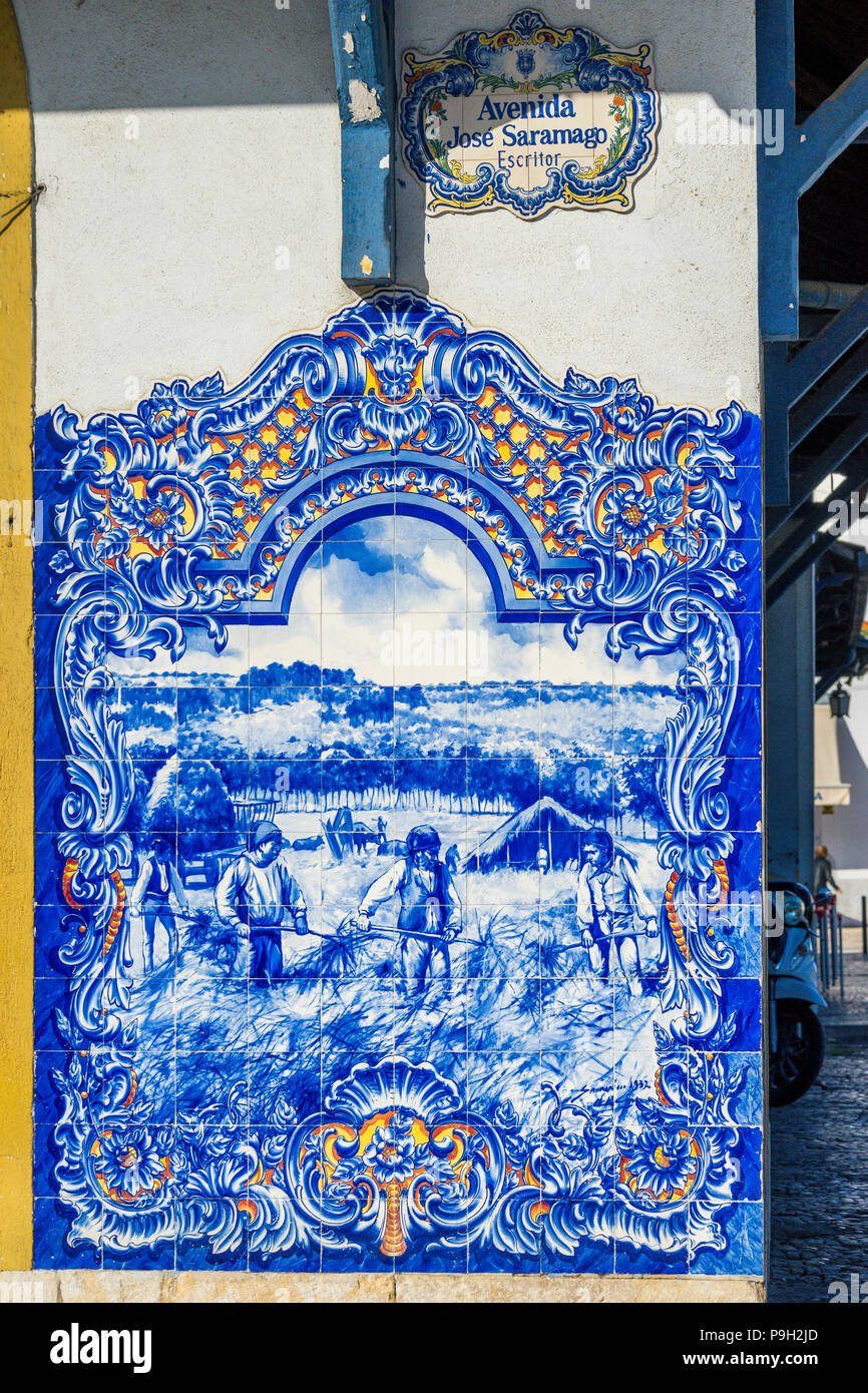 Azulejo tiles on the wall of the county market place in Santarem Portugal depicting workers in the field Stock Photo