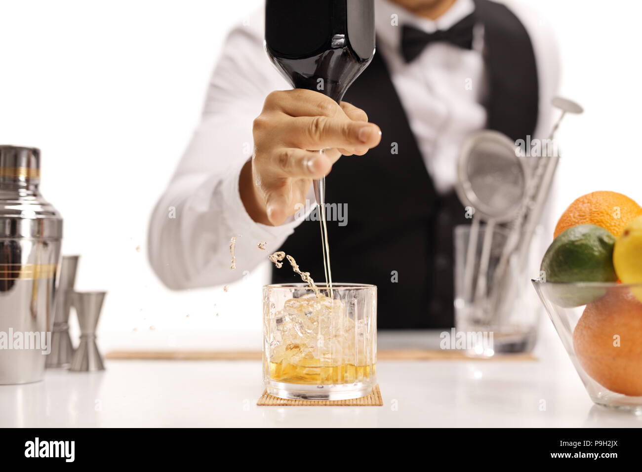 Barman pouring whiskey isolated on white background Stock Photo