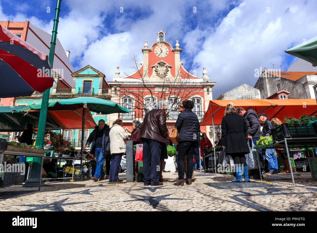Shoppers standing around and chatting at the Praca da Fruta market place, Caldas da Rainha Portugal Stock Photo