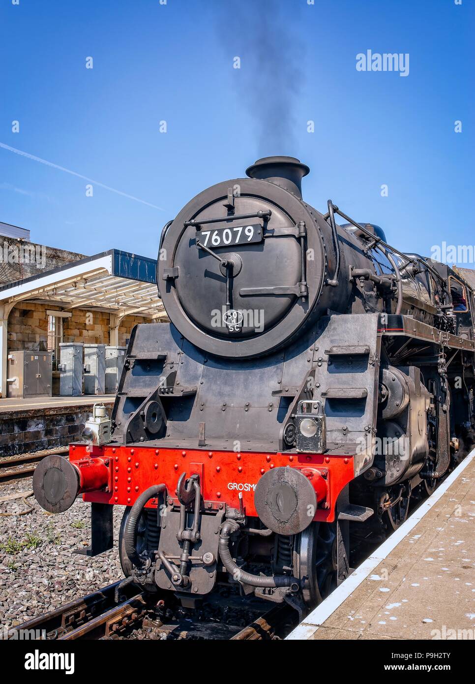 An old steam locomotive of the North Yorkshire Moors Railway stands in Whitby station.  Picking up steam, it gets ready to depart. Stock Photo