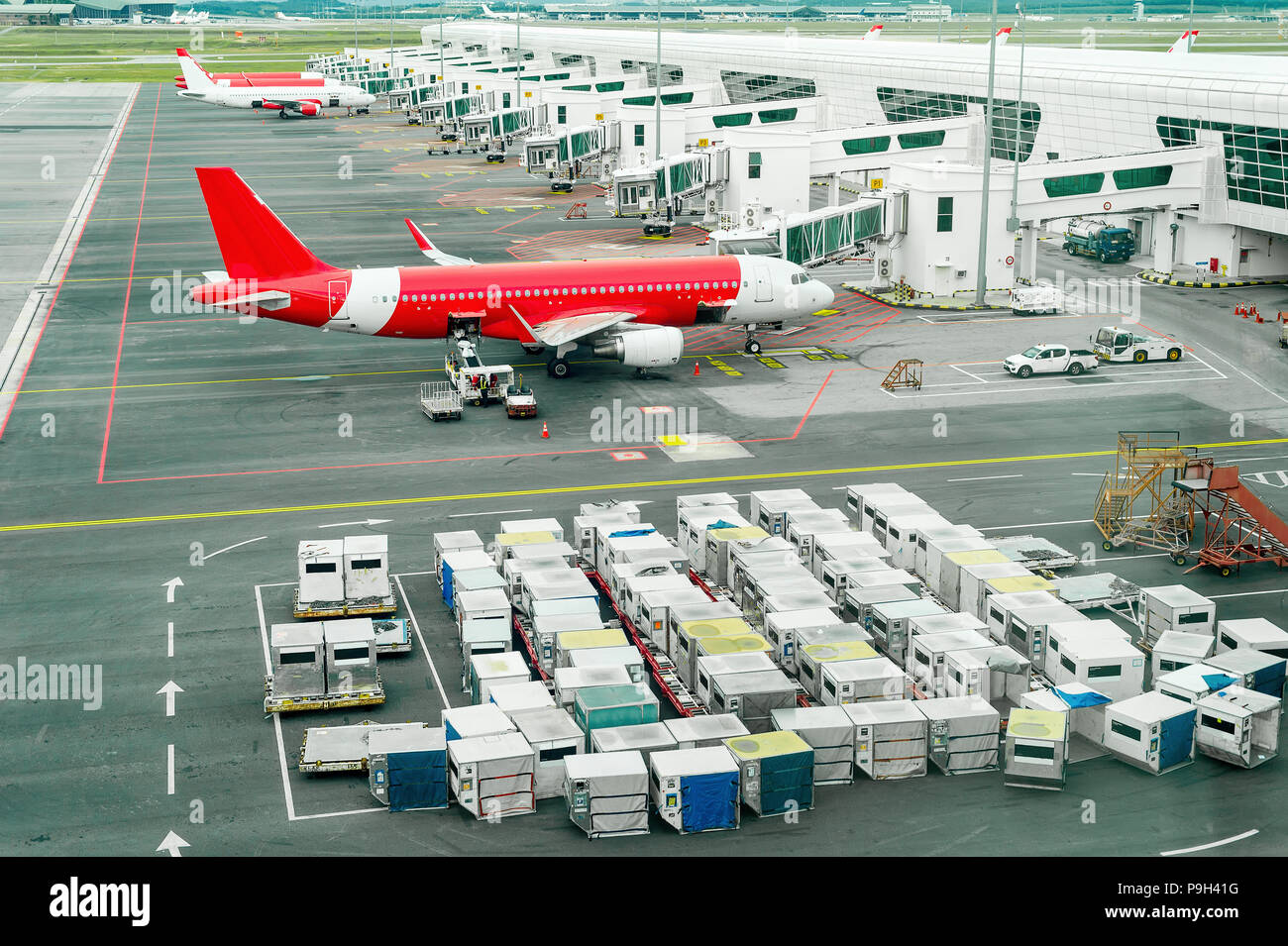 Airplains and freight containers in airport of Kuala Lumpur, Malaysia Stock Photo