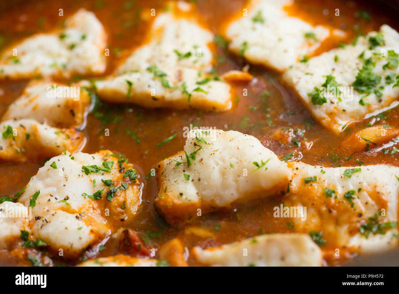A fish stew of onions, garlic, tomatoes, mixed herbs and fish stock