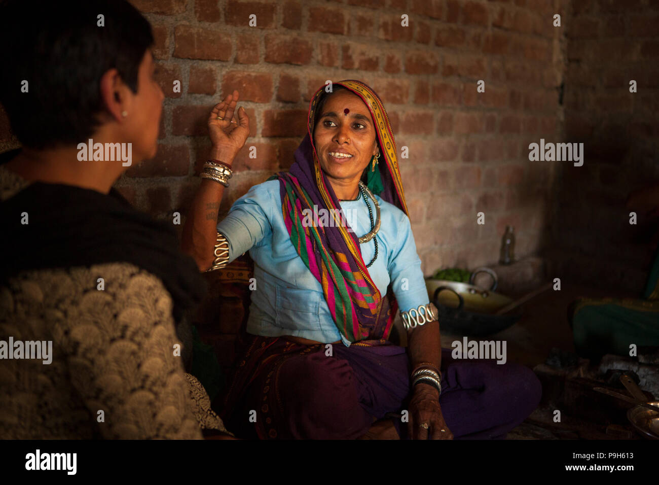 A group of women discussing organic farming in the kitchen of their farm home in rural India. Stock Photo