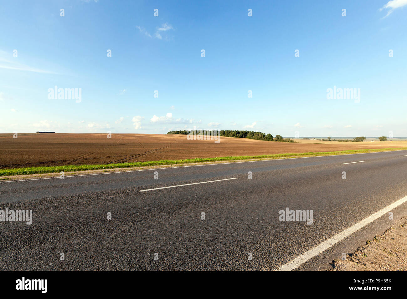 landscape with road, field and blue sky in autumn Stock Photo - Alamy