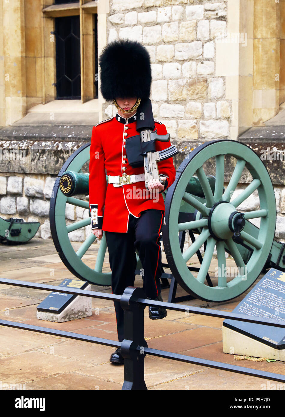 A member of the Queen's Guard marches and stands sentinal at the Tower of London in London, England. Stock Photo