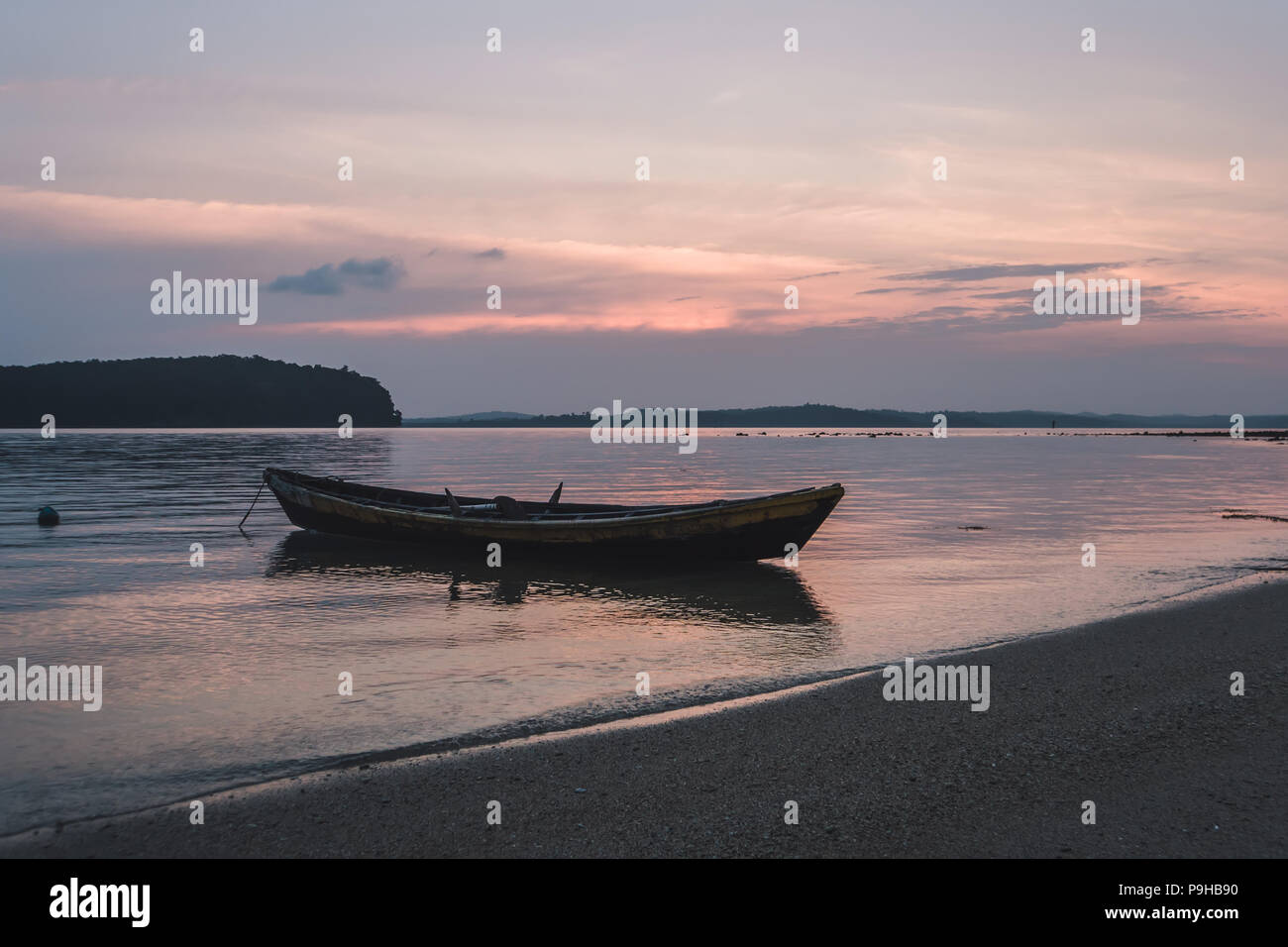 A boat is floating on River Ganges at the time of Sunrise in Varanasi, India. Stock Photo