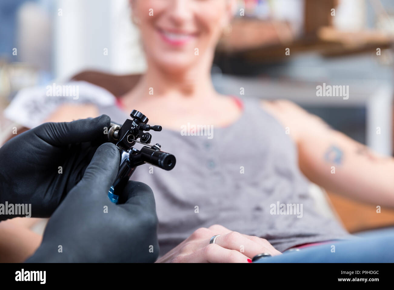 Hands of tattoo artist wearing sterile gloves Stock Photo Alamy