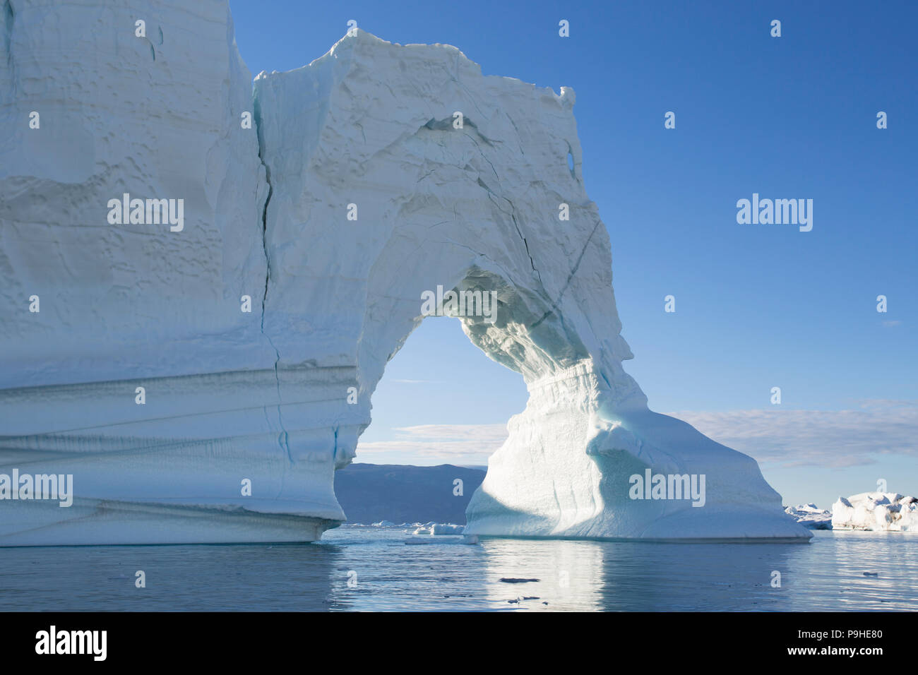 Iceberg arch, Scoresby Sound, Greenland Stock Photo