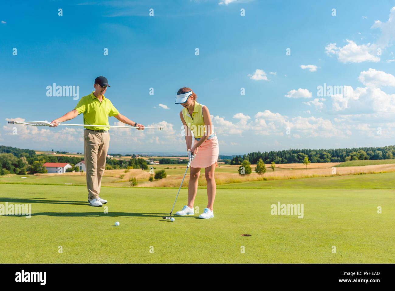 Full length of a woman playing professional golf with her male match partner Stock Photo