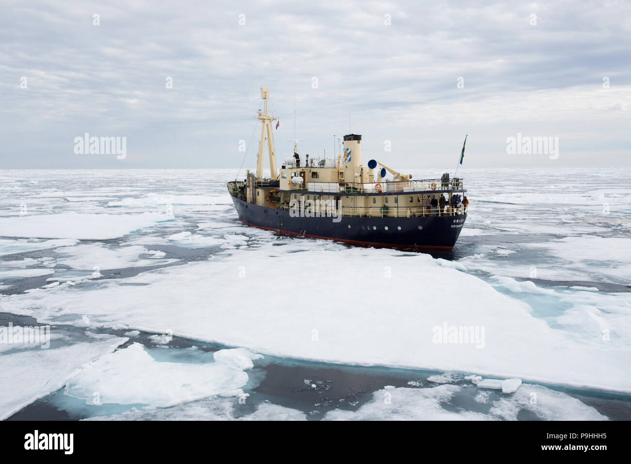 Small ship in sea ice, Svalbard Stock Photo