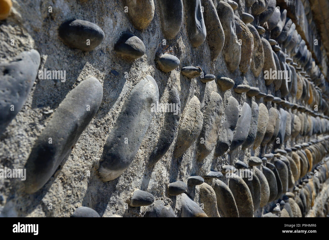 Image showcasing Close-up of the concrete wall with pebbles Stock Photo - Alamy