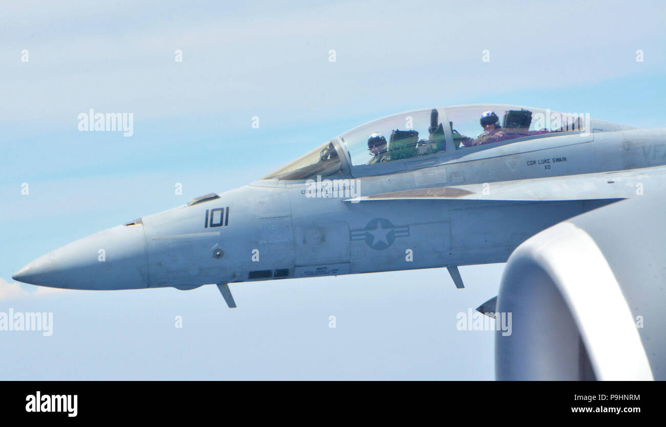 180710-F-FS041-1147 JOINT BASE PEARL HARBOR-HICKAM, Hawaii (July 10, 2018) -  A U.S. Navy F/A-18F Super Hornet from Strike Fighter Squadron Two, based out of Naval Air Station Lemoore, California, flies alongside a 507th Air Refueling Wing KC-135R Stratotanker from Tinker Air Force Base, Oklahoma, July 10, while participating in the Rim of the Pacific (RIMPAC) exercise. Twenty-five nations, 46 ships, five submarines, and about 200 aircraft and 25,000 personnel are participating in RIMPAC from June 27 to Aug. 2 in and around the Hawaiian Islands and Southern California. The world’s largest inte Stock Photo