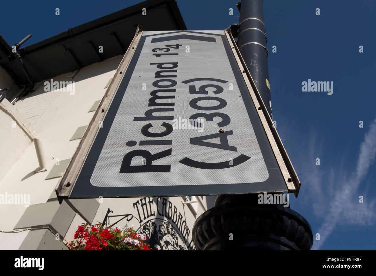 misplaced road sign giving directions for richmond and the A305 road, in twickenham, middlesex, england Stock Photo