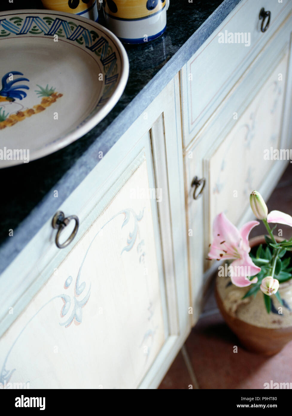 Close-up of kitchen unit with hand-decorated doors Stock Photo