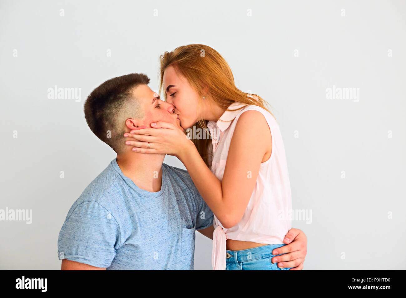 Young couple in love kissing each other at home Stock Photo