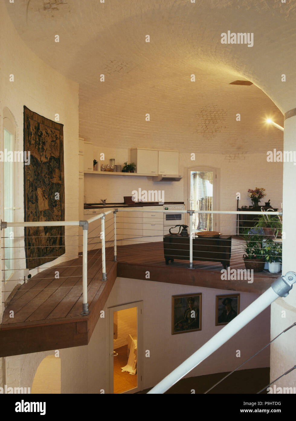 Wooden flooring in modern kitchen on mezzanine floor in converted Martello Tower Stock Photo