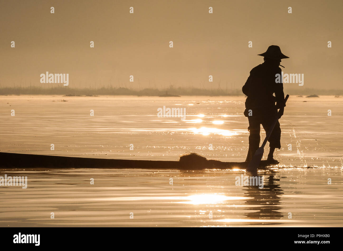 Silhouette of a fisherman in Myanmar (Burma) on Inle lake during ...