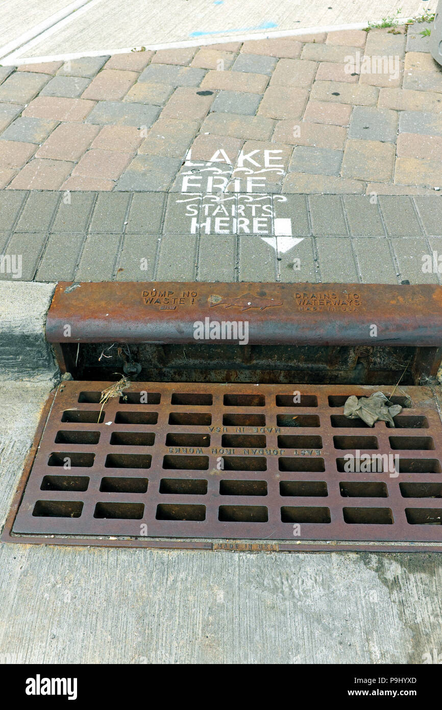 'Lake Erie starts here' with an arrow to the sewer makes a statement about the environmental impacts of polluting the sewer system in Cleveland, Ohio. Stock Photo