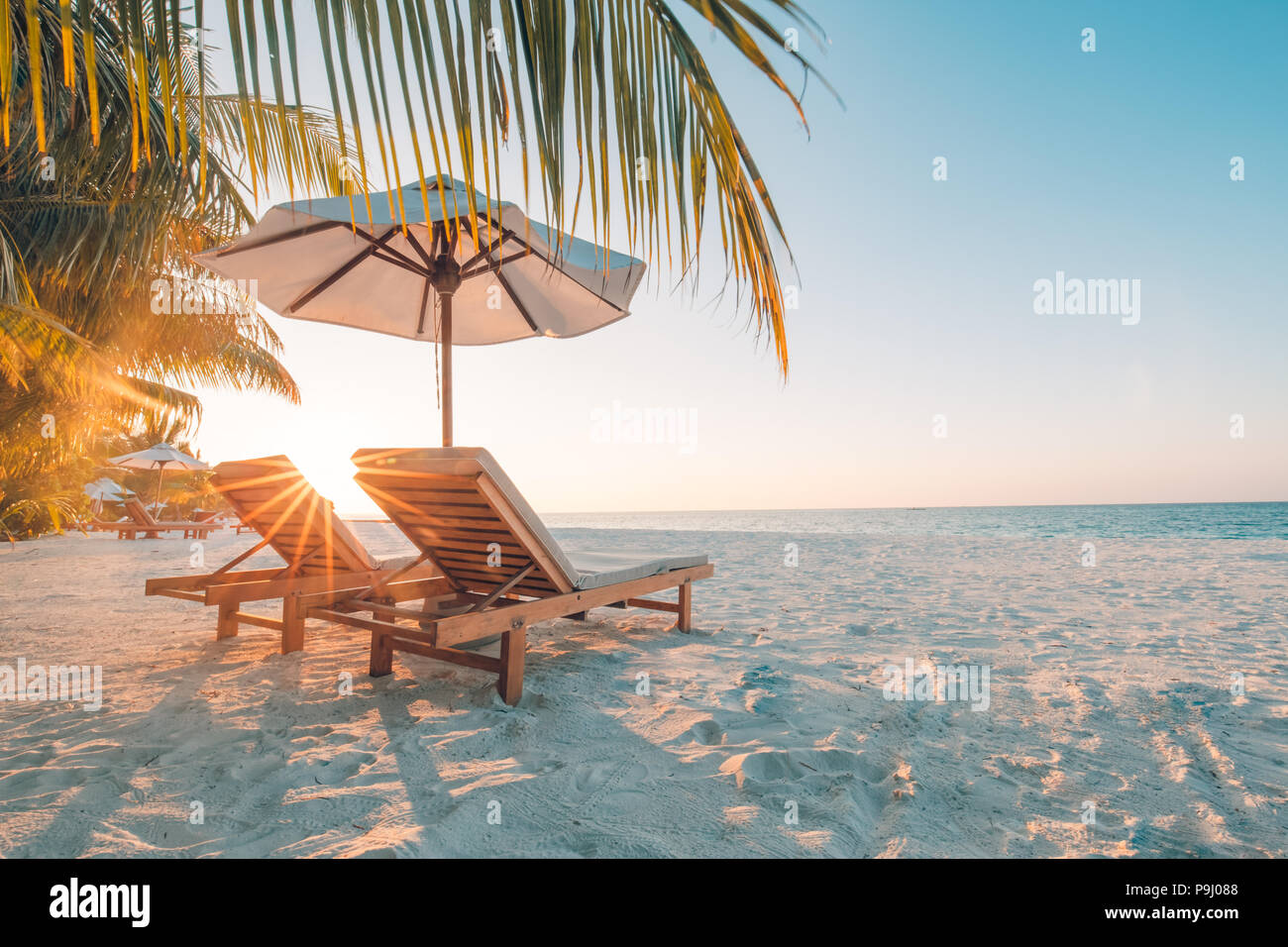 Tranquil scenery, relaxing beach, tropical landscape design. Summer vacation travel holiday design. Sunset beach view. Inspirational beaches, resort Stock Photo
