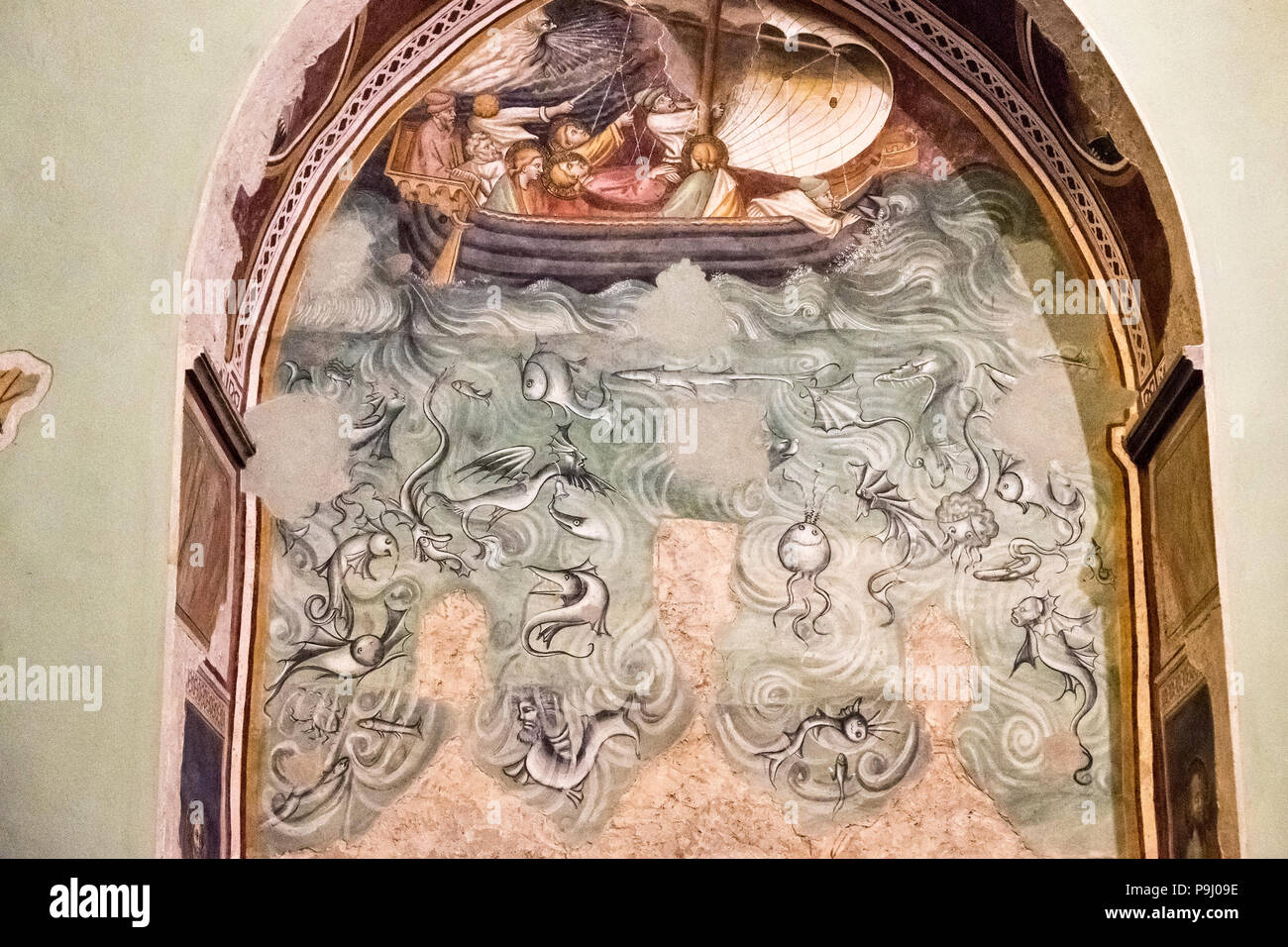 Church of San Domenico (1330), San Miniato, Italy. 14c fresco of the body of St James being taken to Spain with weird sea creatures in the ocean below Stock Photo