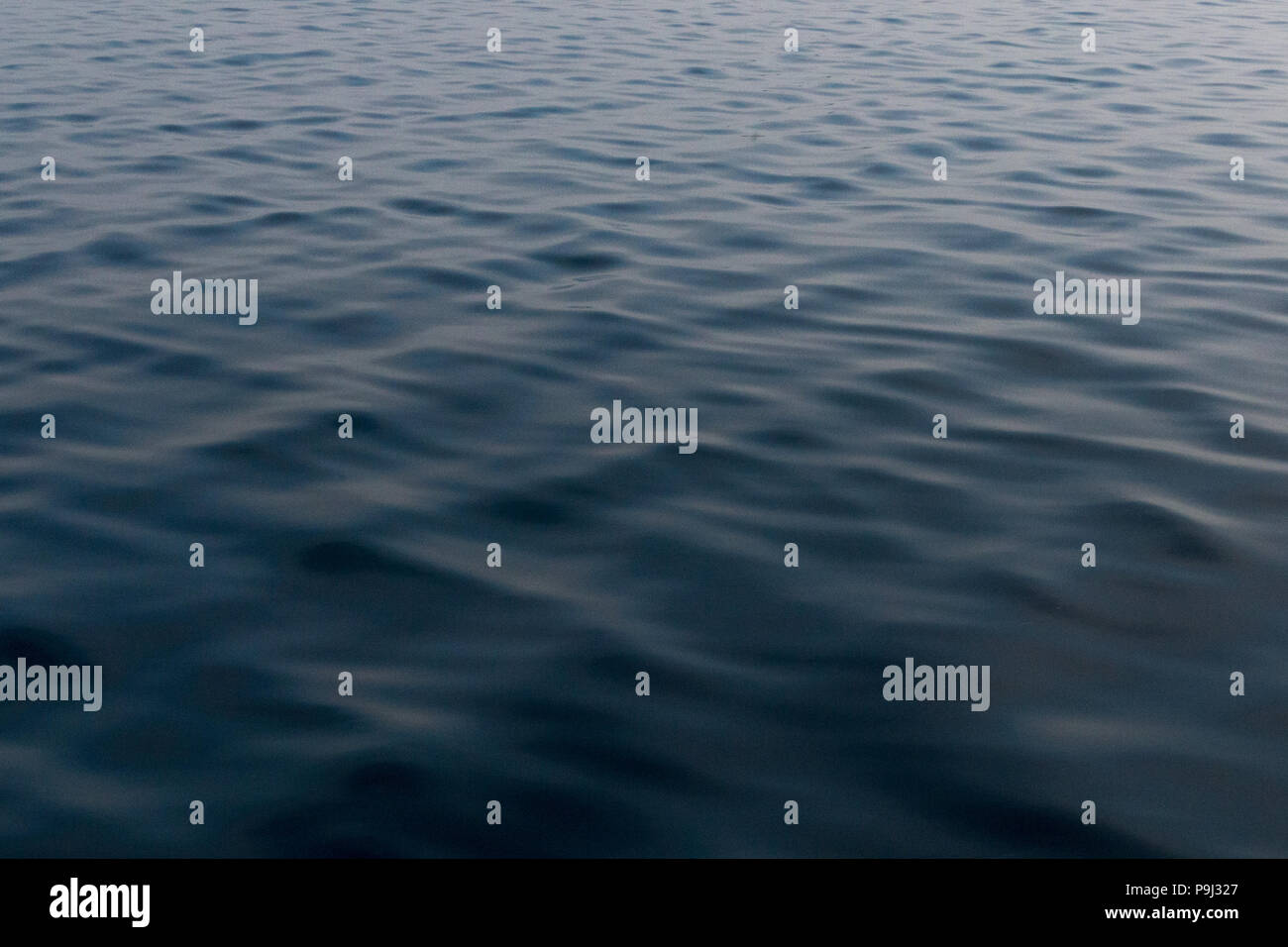 Calm Lake Huron water with ripples in the early morning background wallpaper Stock Photo
