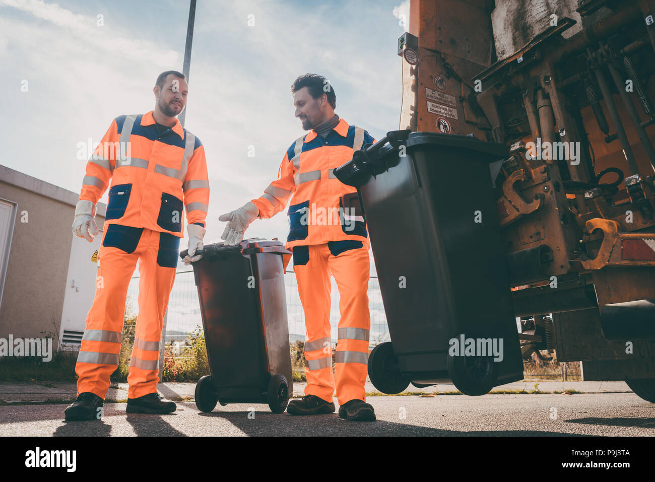 Garbage removal men working for a public utility Stock Photo Alamy