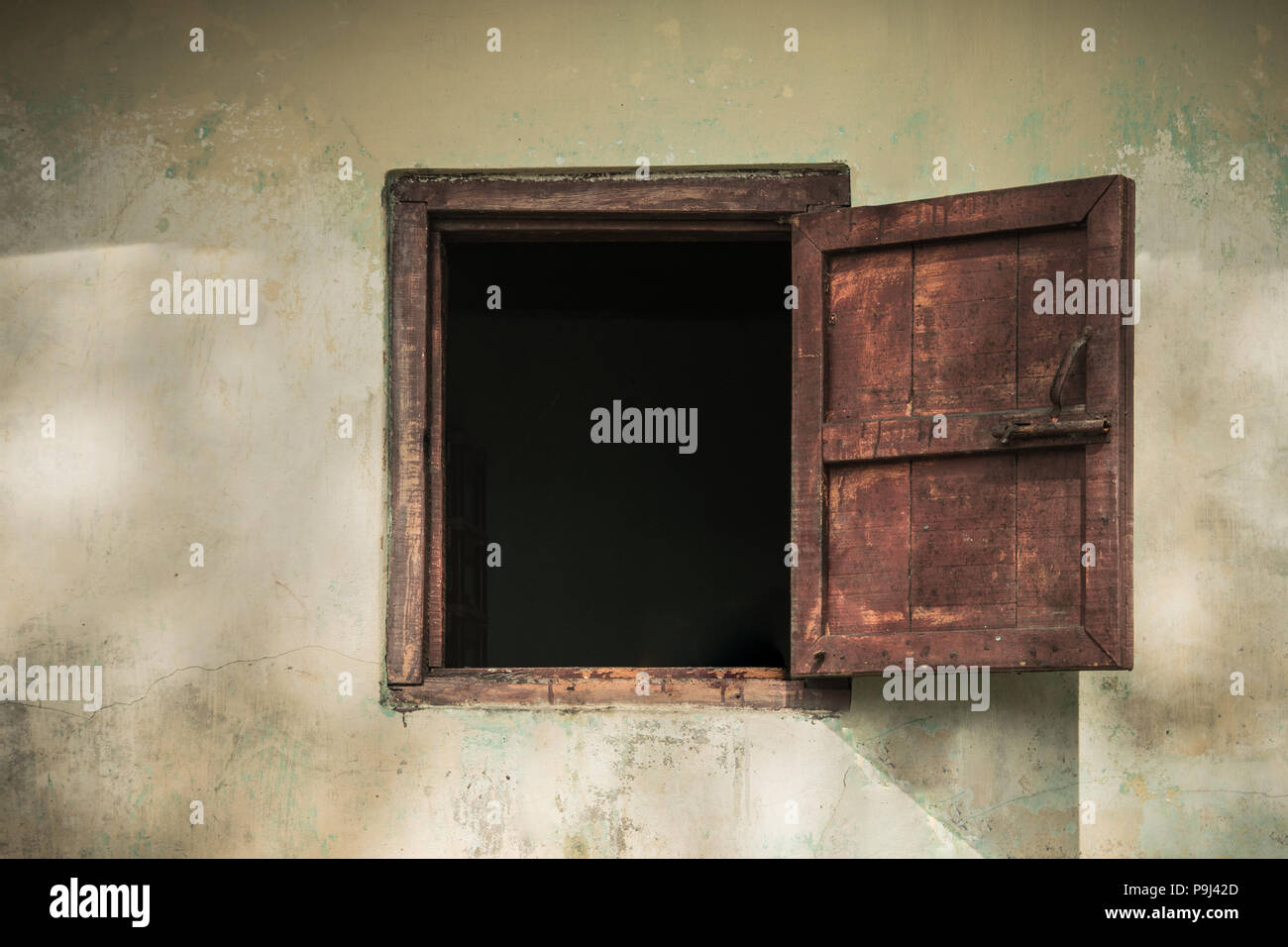 Open old window on the old house. Stock Photo