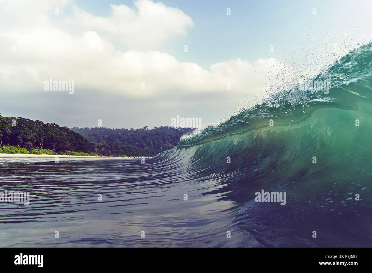 Looking at a barreling wave break in an empty line up. under the crest of a wave. crest of wave Stock Photo