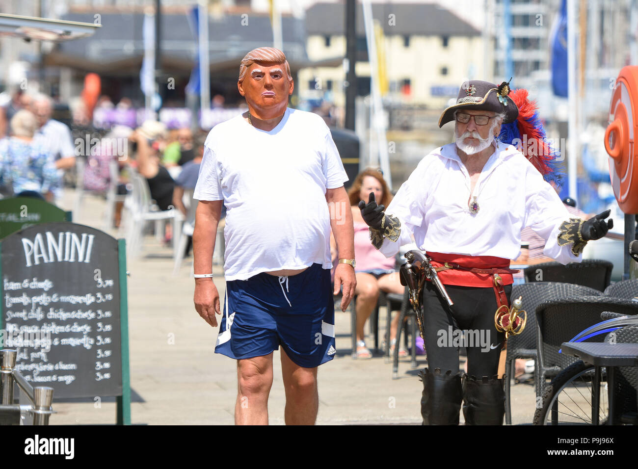 Man in Donald Trump mask enjoying the sun in Plymouth,Devon,UK Stock Photo