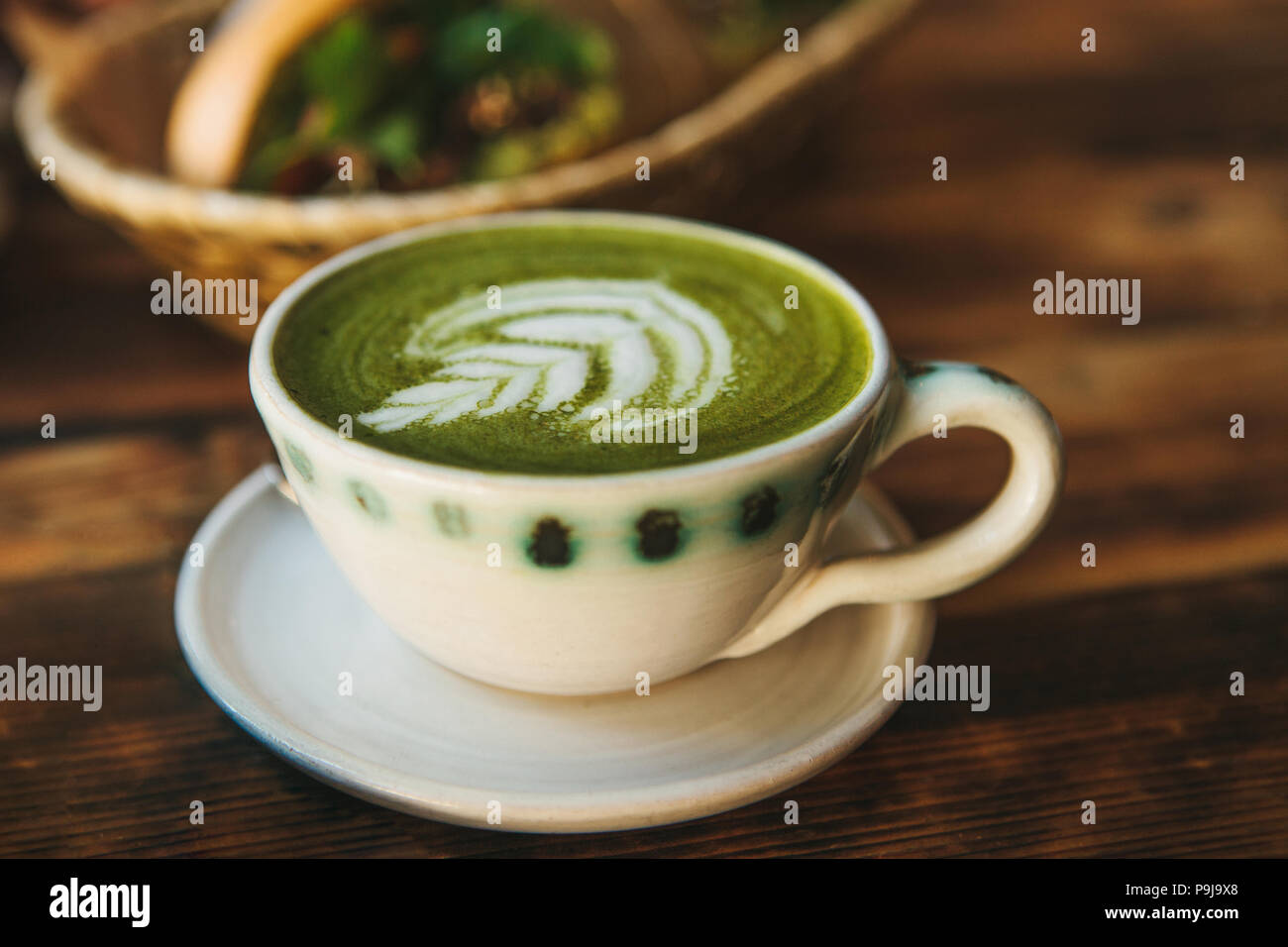 Close-up - A cup of green tea called Matcha tea or green coffee with a pattern. Stock Photo
