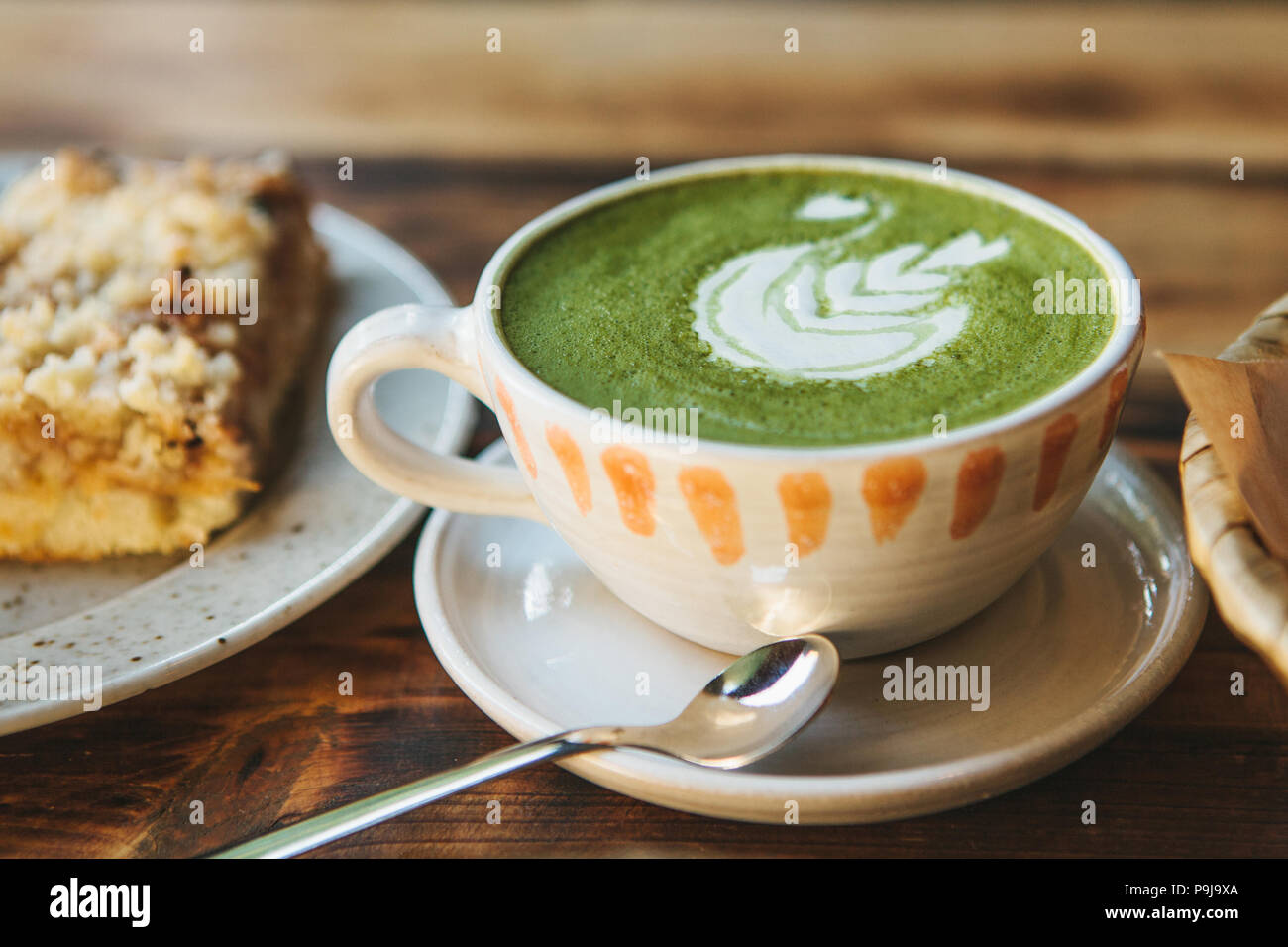 Close-up - A cup of green tea called Matcha tea or green coffee with a pattern. Stock Photo