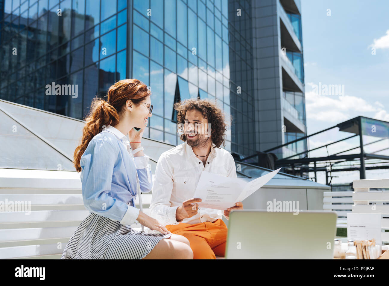 Two young creative designers working on summer terrace Stock Photo
