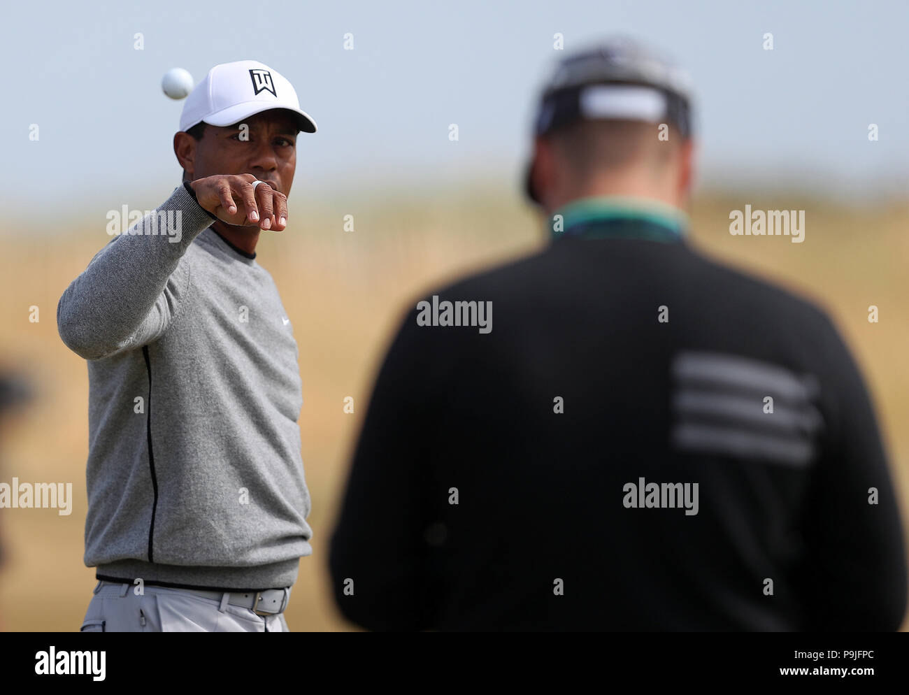 USA's Tiger Woods catches a ball on the driving range during preview