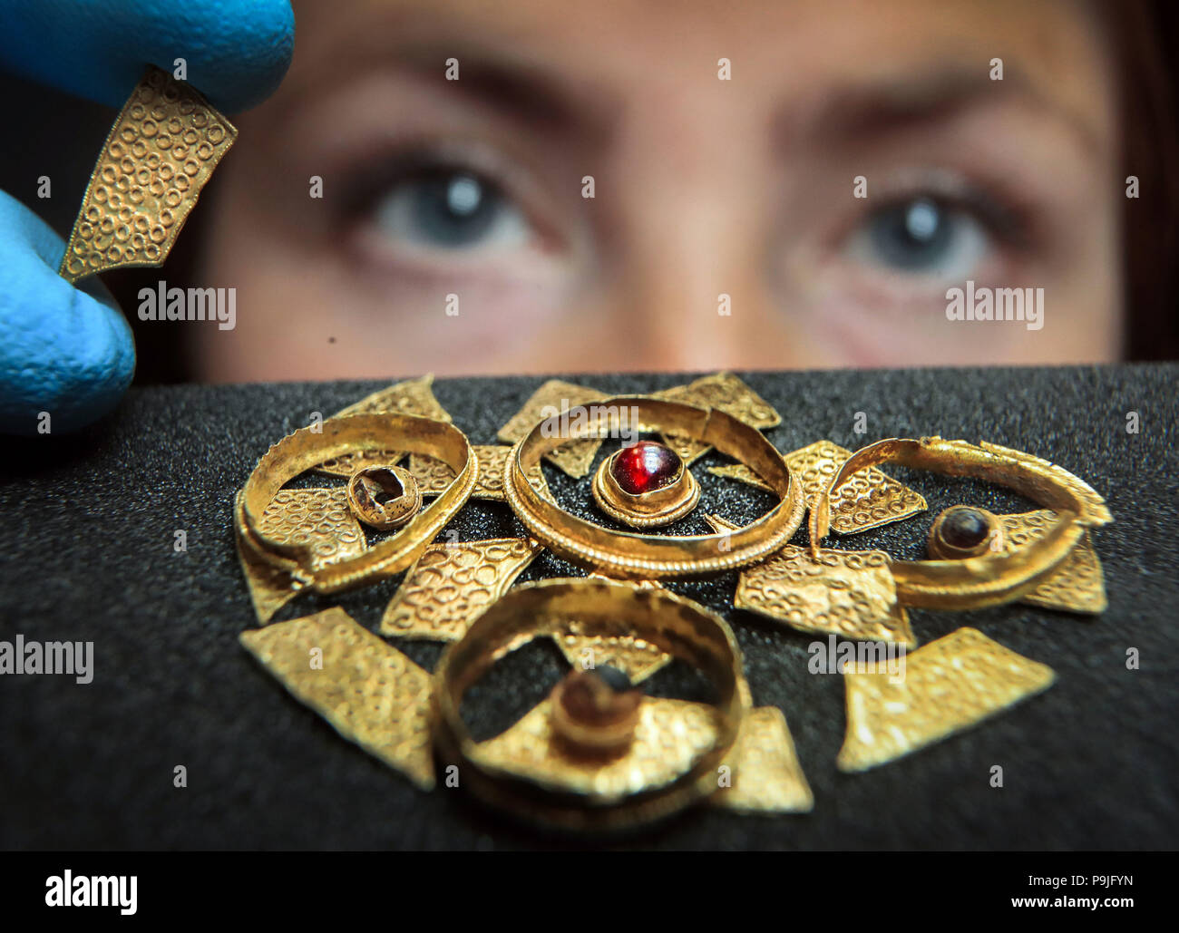 Curator of Archaeology Lucy Creighton with an seventh century Anglo-Saxon disc brooch, believed to have come from the burial of a noblewoman, that has recently been acquired by the Yorkshire Museum in York. Stock Photo