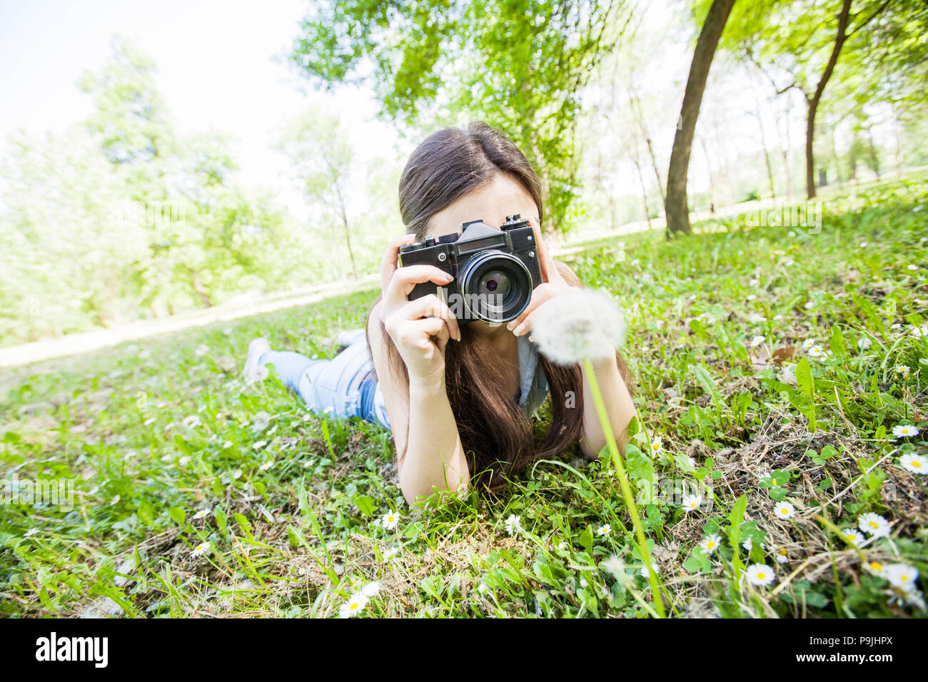Young Woman Amateur Photographer taking photos with vintage camera in  nature Stock Photo - Alamy