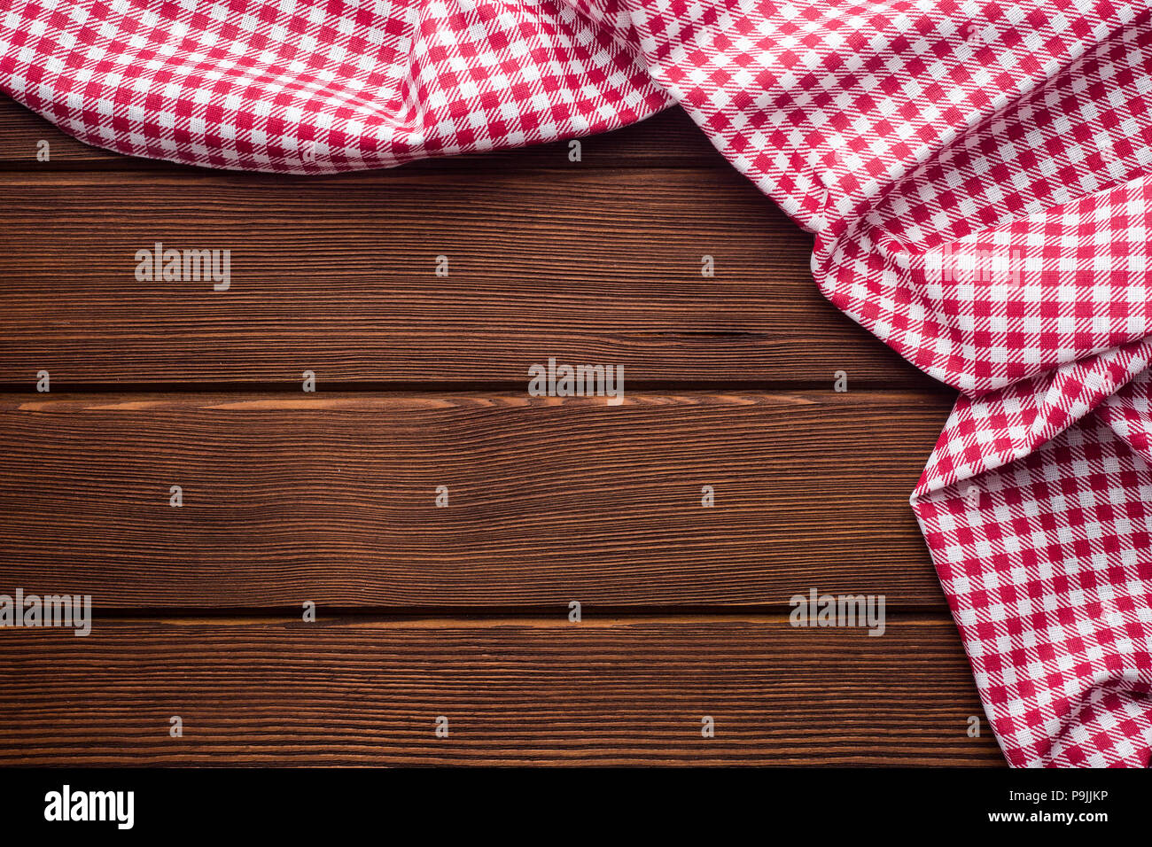 Napkin in a red and white cage on a wooden background, texture,  Stock Photo