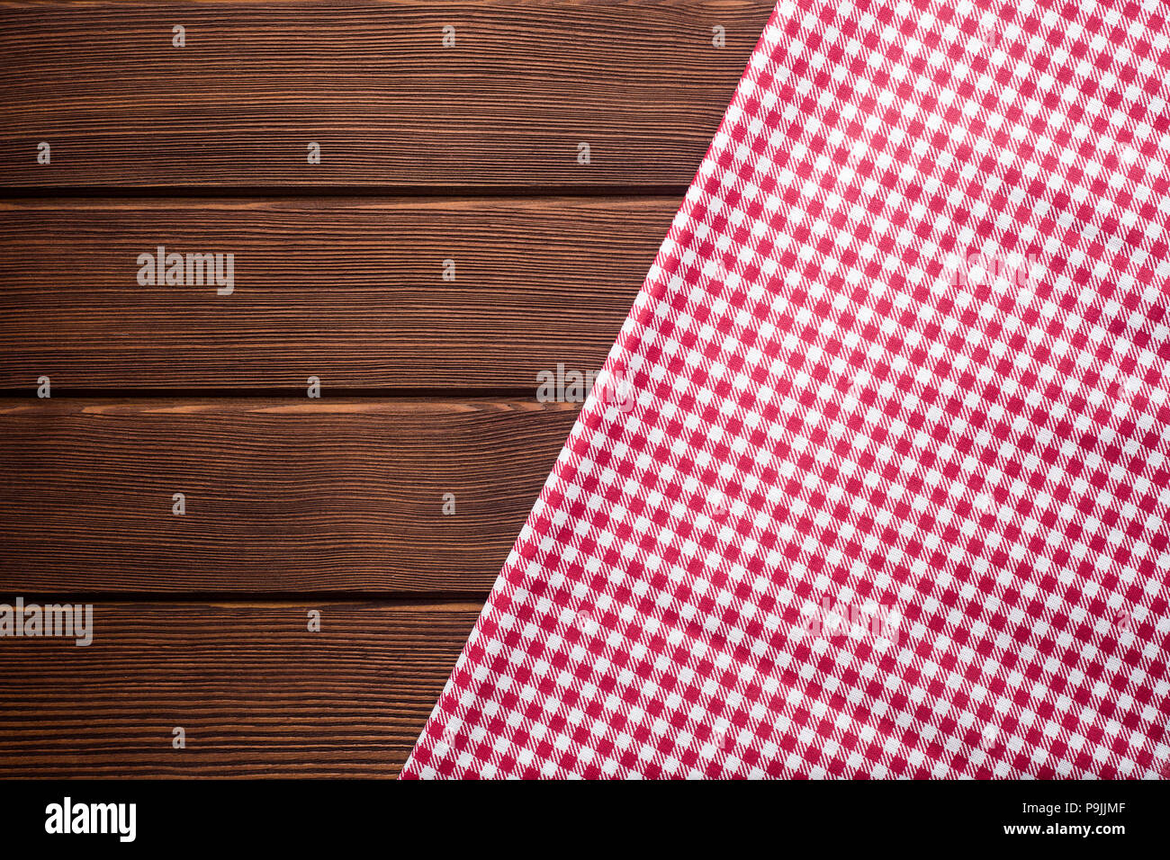 Napkin in a red and white cage on a wooden background, texture,  Stock Photo
