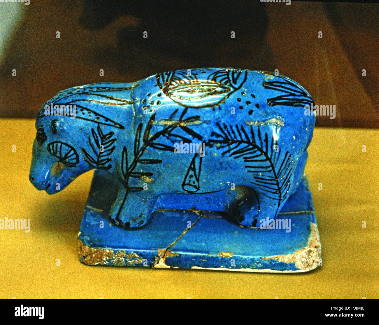 Hippo, blue glazed ceramic figurine, side view. Stock Photo