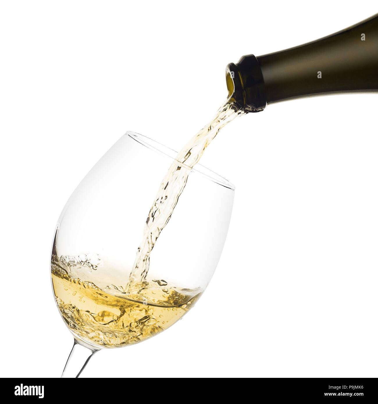 white wine poured from a bottle into wine glass on white backgro Stock
