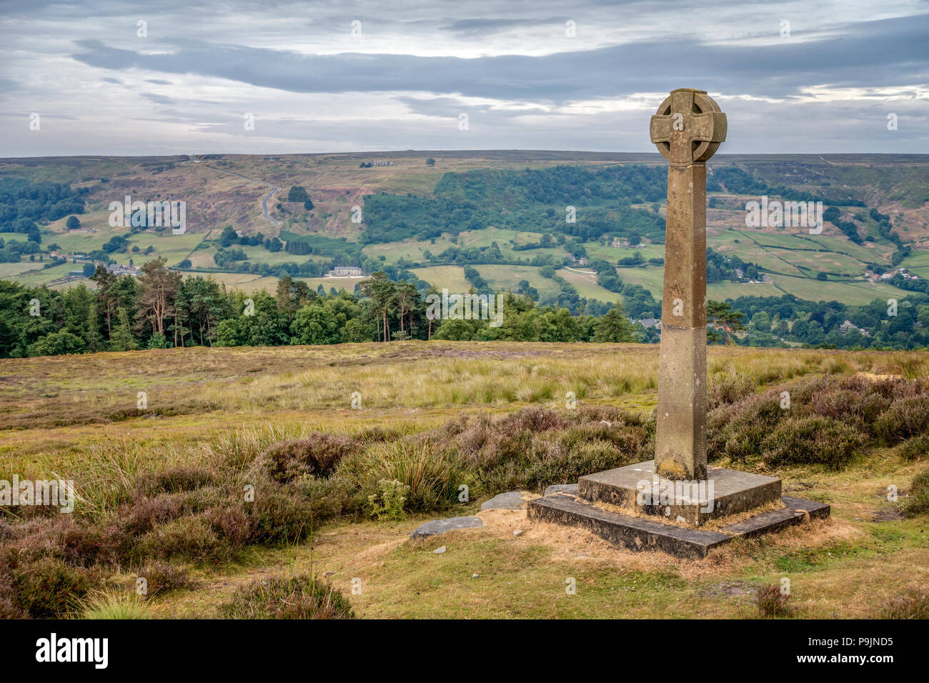 Millennium Cross at Rosedale Abbey  with Chimney Bank road in the background on The North York Moors, England  The cross was erected to mark the Stock Photo