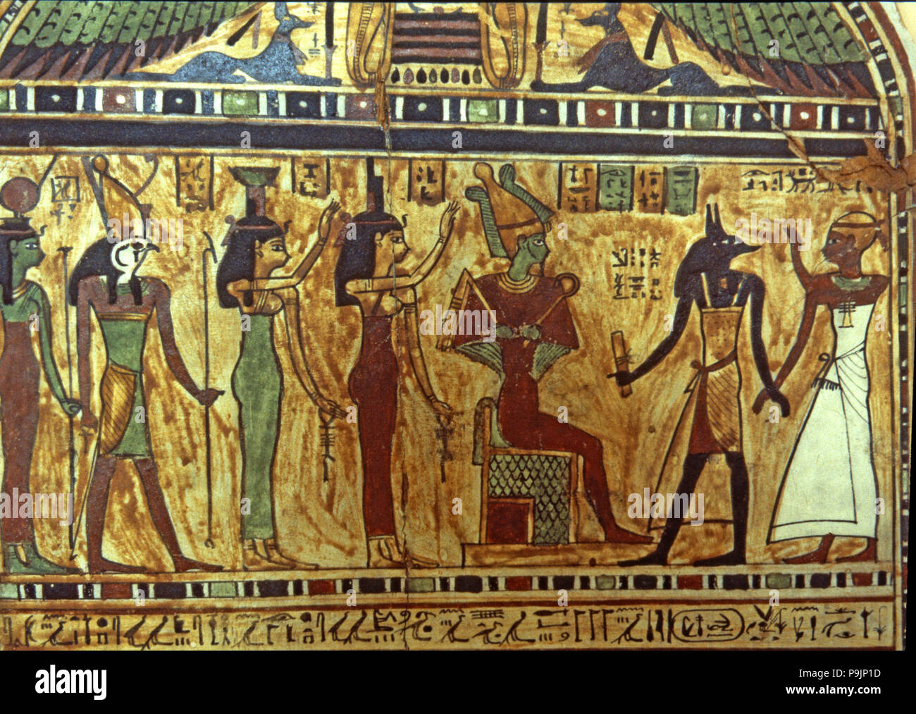 Anubis presents the deceased to Osiris, with Horus and other deities present, funerary stela from… Stock Photo